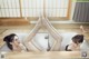 A couple of women laying in a bathtub with their feet up.