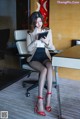 A woman sitting at a desk using a tablet computer.