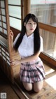 A young woman in a school uniform posing for a picture.