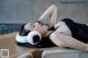 A woman laying on a couch wearing a pair of ear muffs.