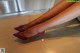 A close up of a woman's legs wearing red high heels.