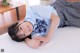 A young woman laying on top of a bed.