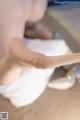 A close up of a person holding a pair of shoes.